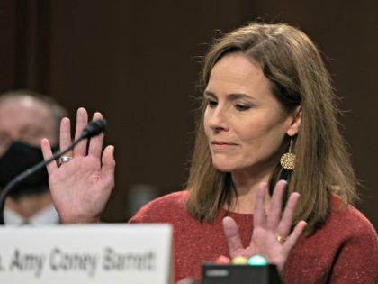 WASHINGTON, DC - OCTOBER 13: Supreme Court nominee Judge Amy Coney Barrett reacts while te