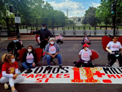 Activist from migrants organizations Cosecha (Harvest) and TPS Alliance protest near the W