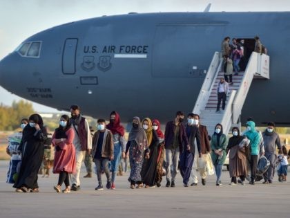 Refugees disembark from a US air force aircraft after an evacuation flight from Kabul at t