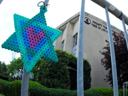 A Star of David hands from a fence outside the dormant landmark Tree of Life synagogue in