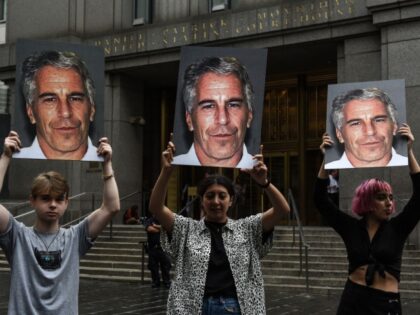 NEW YORK, NY - JULY 08: A protest group called "Hot Mess" hold up signs of Jeffr